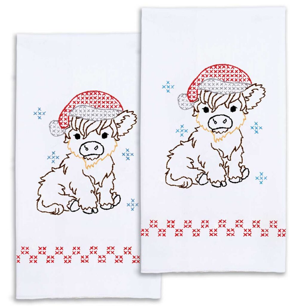 Decorative hand towel kit featuring a Christmas Highland cow design for hand embroidery